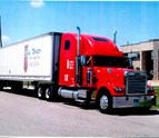 Blue_Water_Trucking_Red_Semi_Truck_on_the_road.jpg