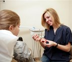 Dentist_at_Union_Square_Dental_explaining_clear_braces_procedure_to_pediatric_patient.jpg